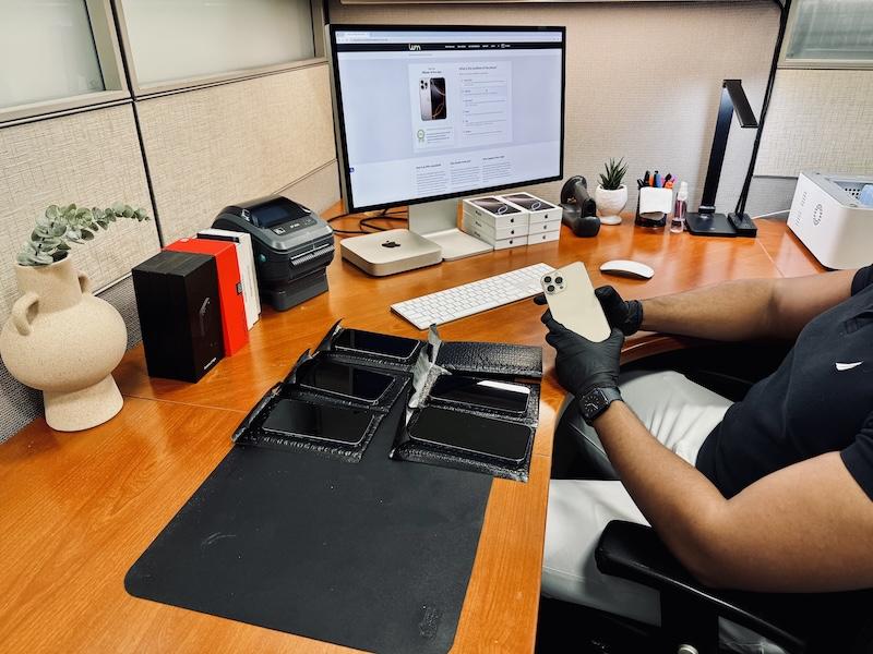 Picture of an employee testing mobile phones